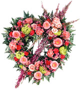 STANDING Eternal Rest Heart Wreat - Share the grief with this resplendent wreath. Pink and purple hues of roses, gerbera daisies, carnations and more are combined in this delicate display. Appropriate to send to the funeral home. Arrangement is delivered with an easel for display. Approx. 29.5H x 2